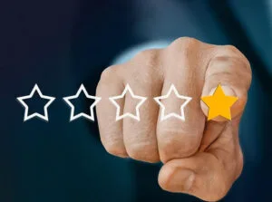 feedback-3083100_1280 A hand touching the 1 star in a 5 star rating system